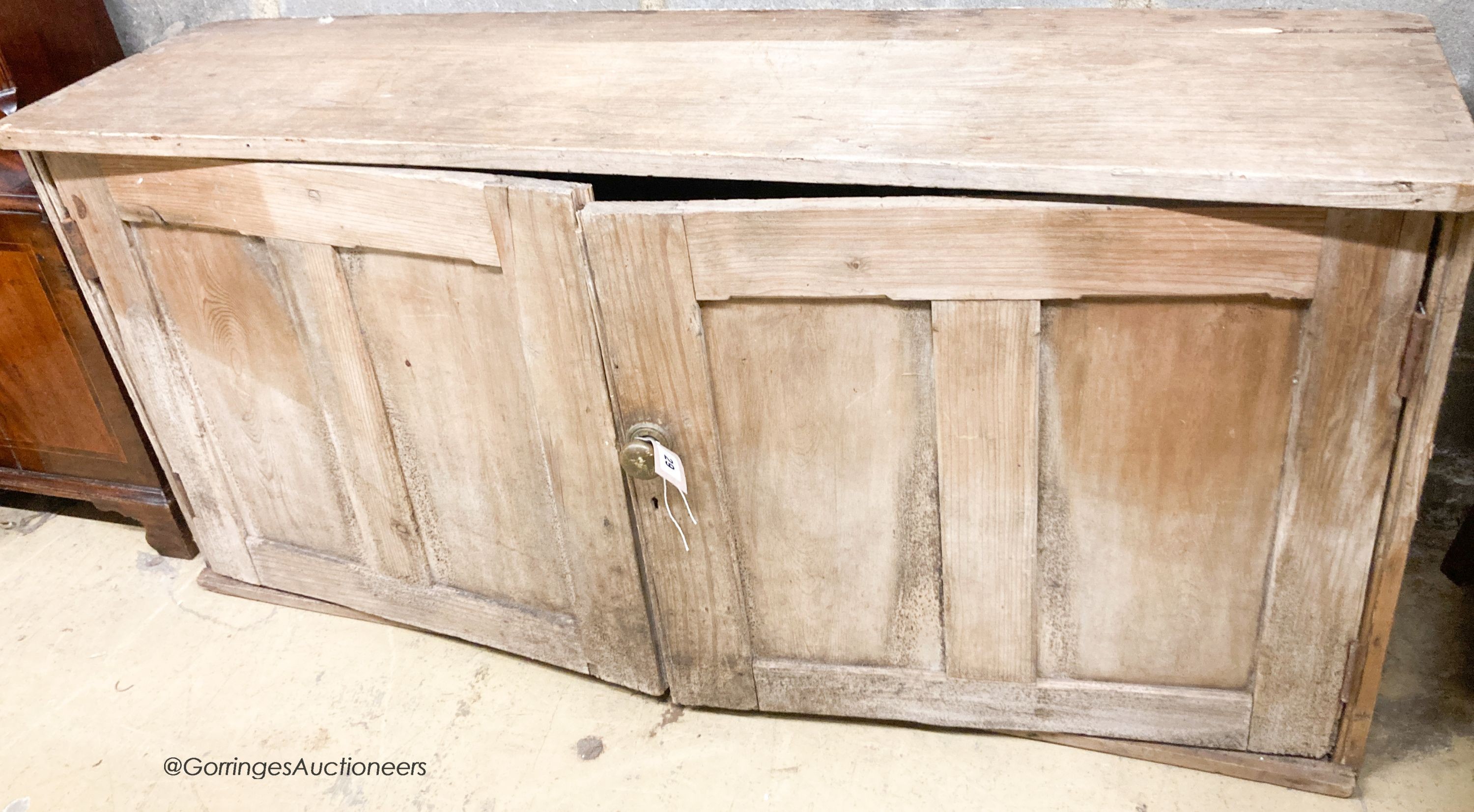 A Victorian pine two door low cupboard, width 122cm, depth 32cm